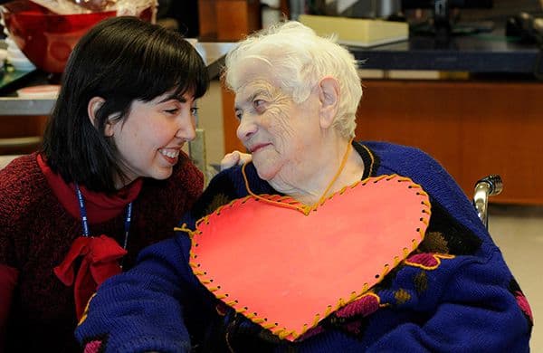 Patient Wearing Paper Heart Smiling with a Woman
