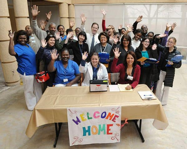 Large Group of MJHS Foundation Employees with Welcome Home Sign