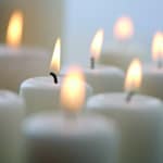 Yahrzeit Memorial Prayers Closeup of Multiple White Lit Candles