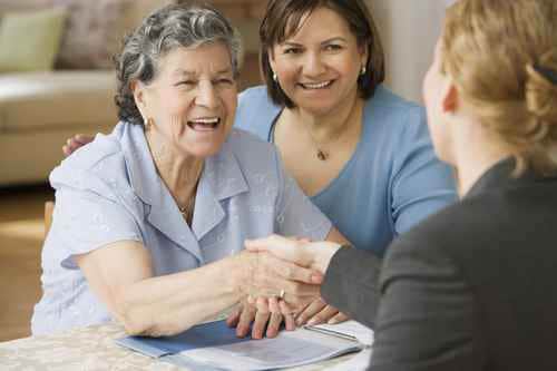 Daughter with Mother Shaking Hands with Employee