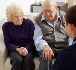 bereavement Nurse Giving Pills to Elderly Couple at Home