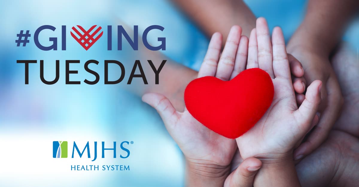 Giving Tuesday at MJHS. Two hands holding heart