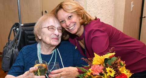 Two woman embracing and smiling