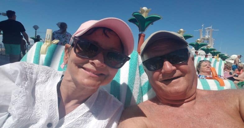 Couple Smiling wearing hats at the beach