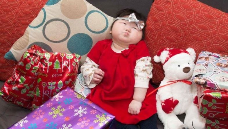 Little Girl Sitting Around Presents