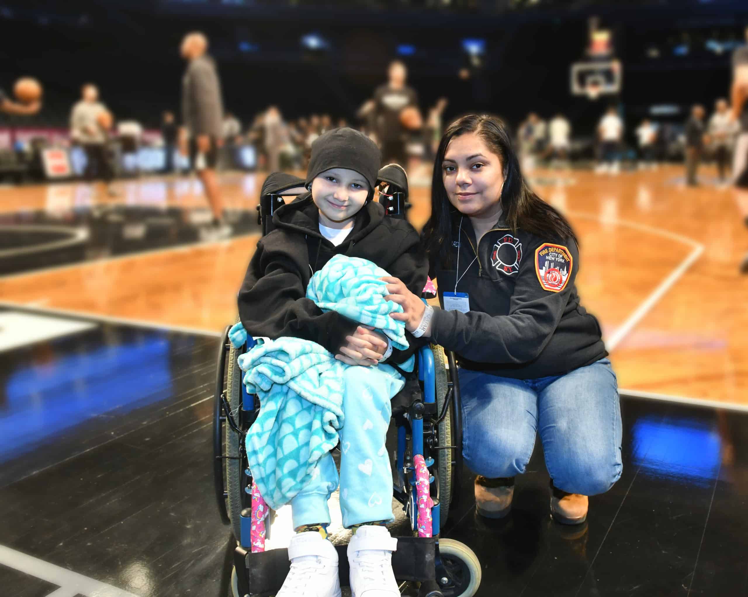 Child in wheel chair in basketball courtt