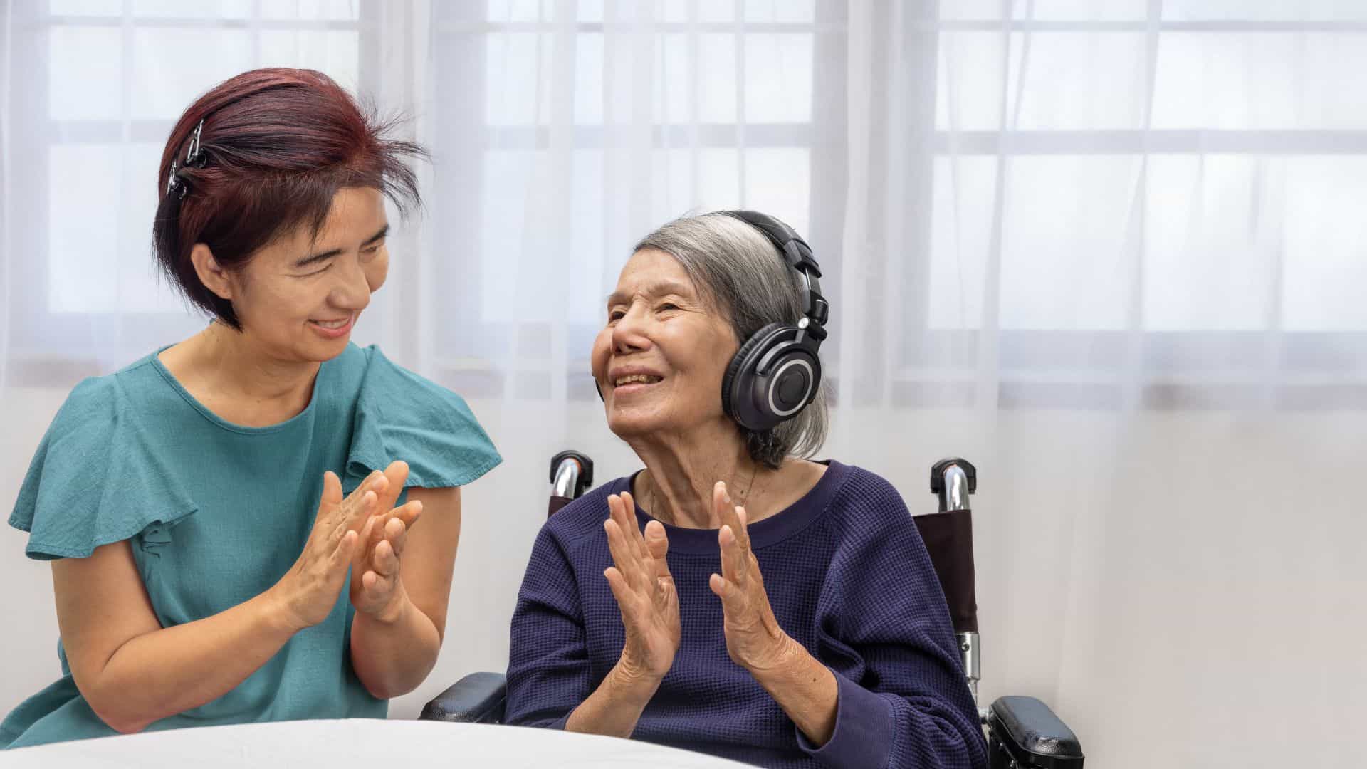 Older woman in a wheel receiving music therapy