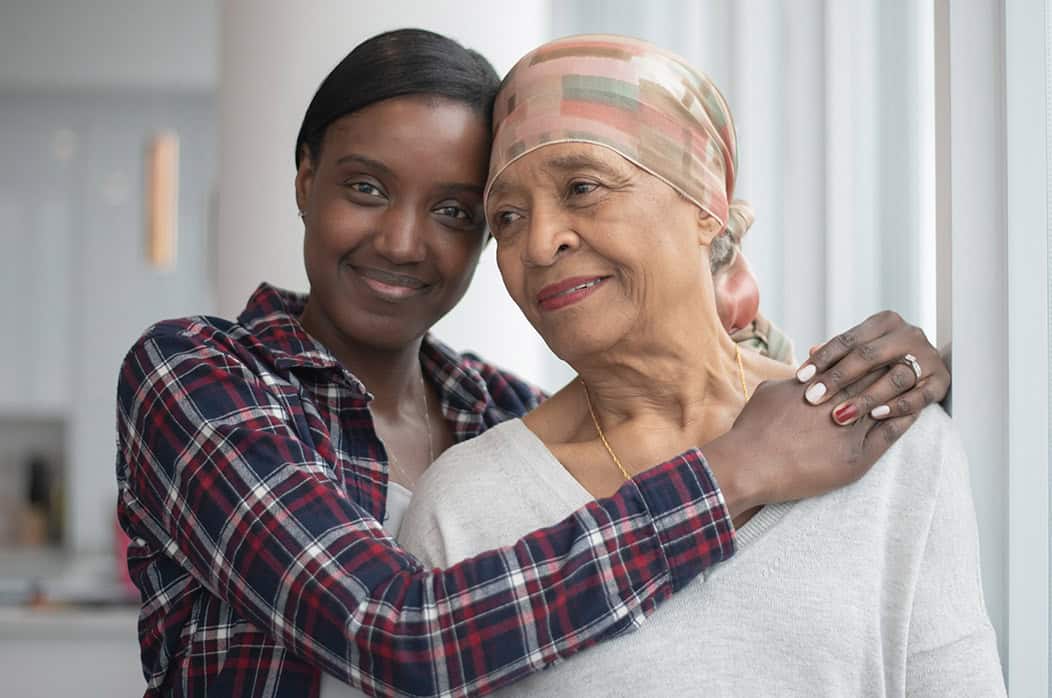 Daughter Hugging Her Mother with Cancer stock photo