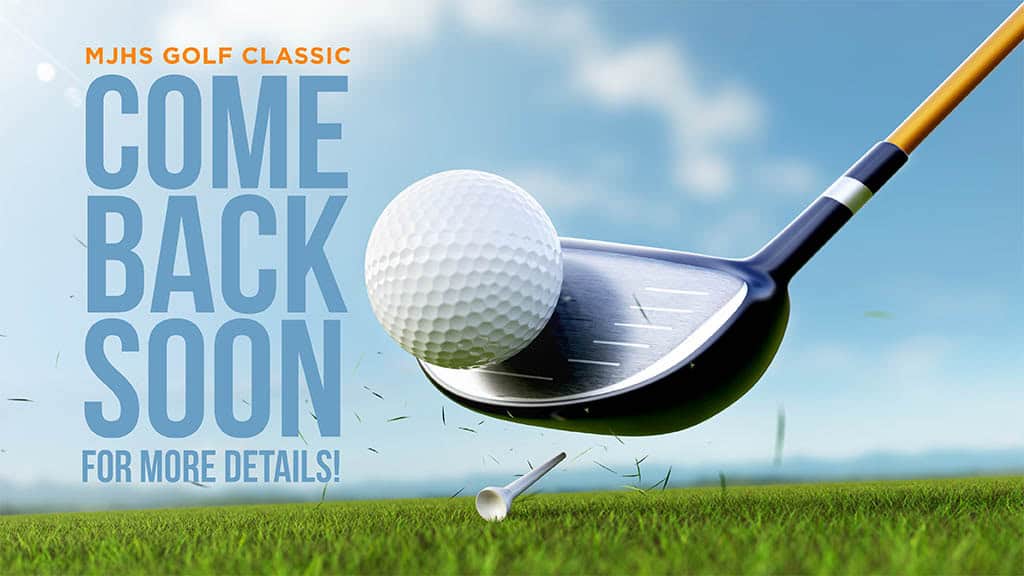 Golf club hitting a ball on green grass