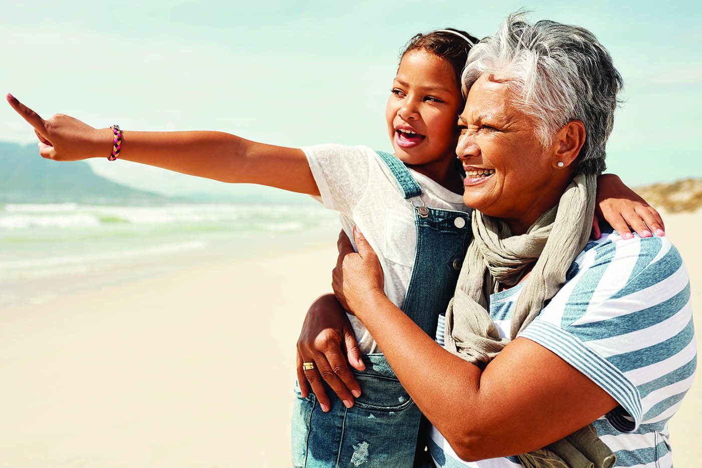 Shot of an adorable little girl having a fun day at the beach with her grandmother